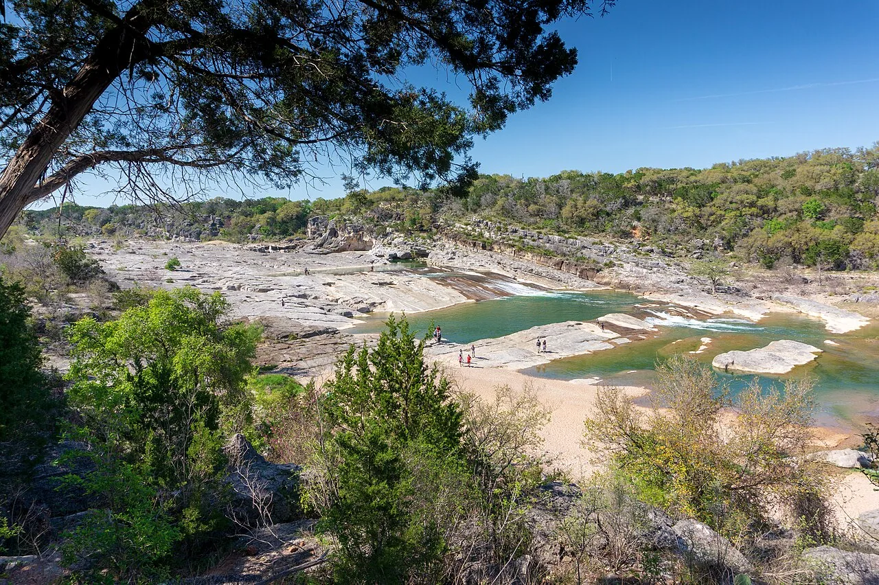 Limestone riverbed and water seen from an overlook at Pedernales Falls State Park