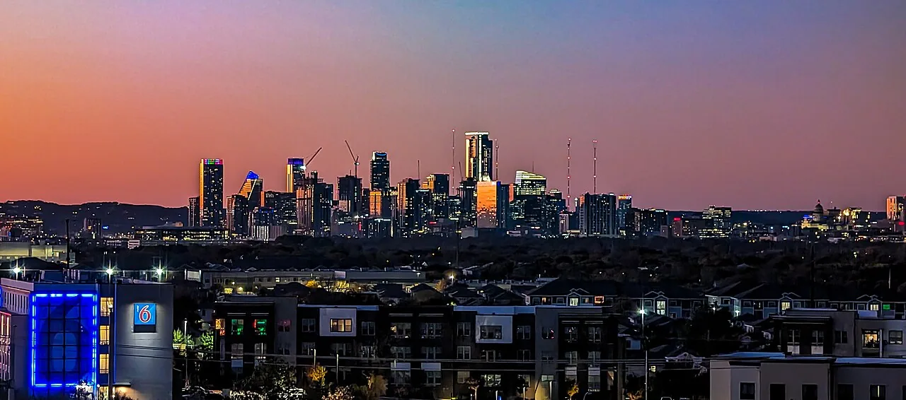 Austin skyline seen across the water in evening light