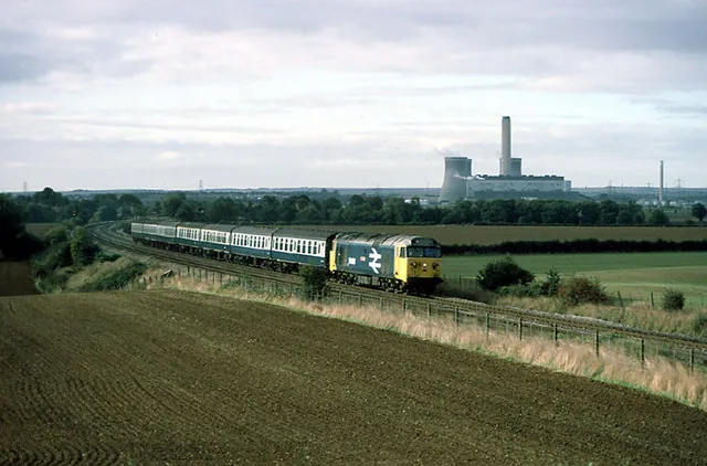Passenger train crossing fields in the Oxfordshire countryside