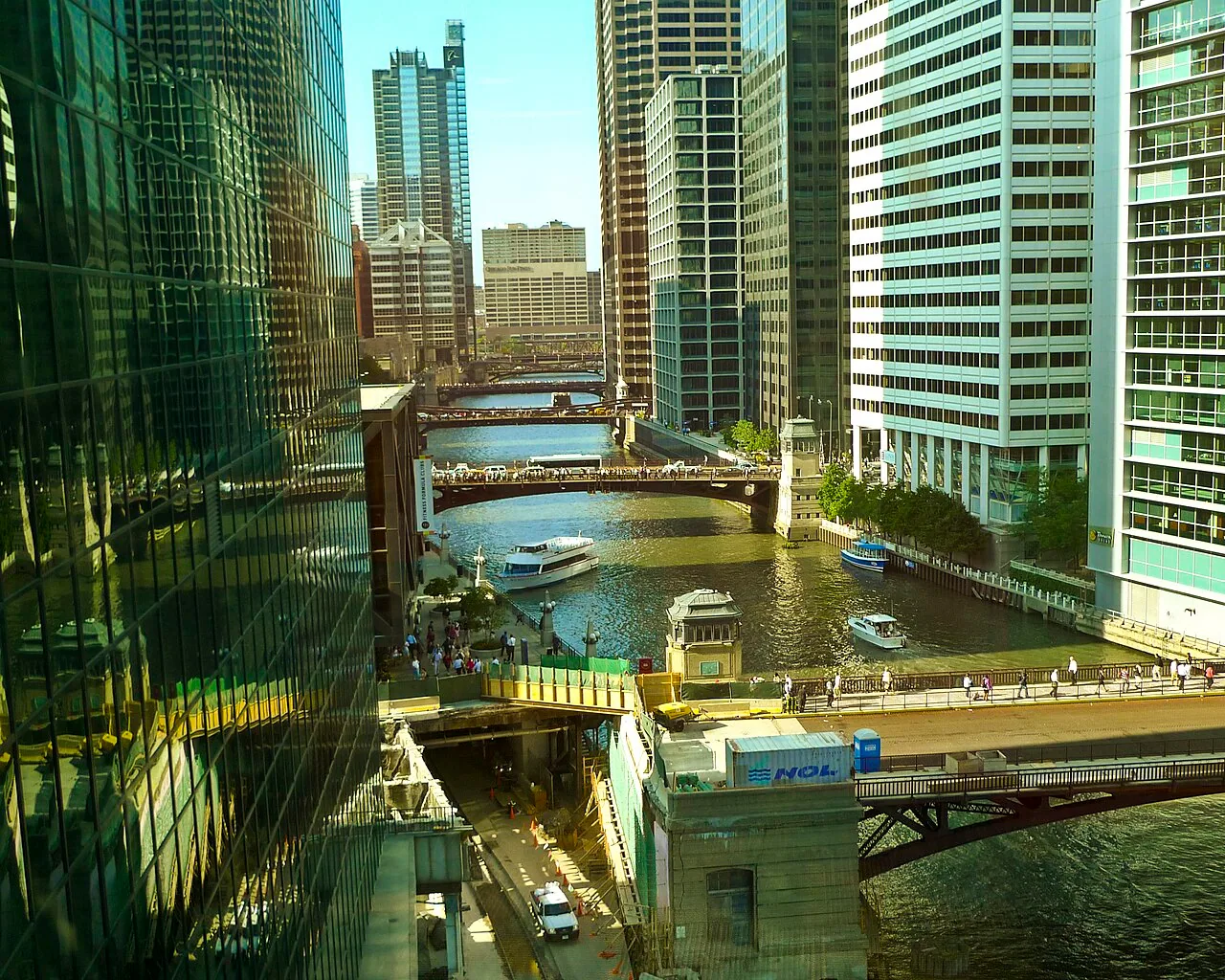 Chicago River and riverfront towers viewed between glass buildings